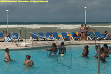 pool volleyball with surf behind